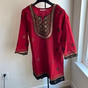 Red shirt made in India with gold, green, and black embroidery
